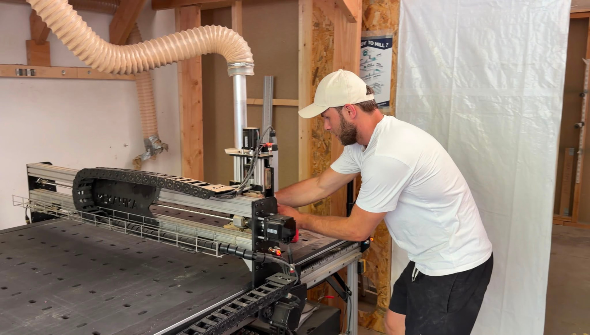 Normunds setting up a cut at the CNC table in the workshop